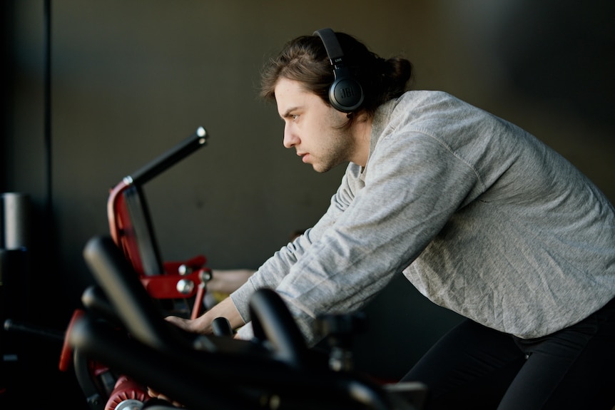 Man wears headphones while cycling