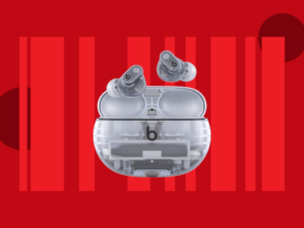 A pair of transparent Beats Studio Buds Plus earbuds are displayed against a red background.